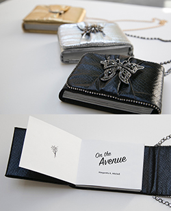 Photo of On the Avenue, a Limited Edition Artist's Book shows the handcrafted purse binding in black, silver and gold; also available in paperbound edition.