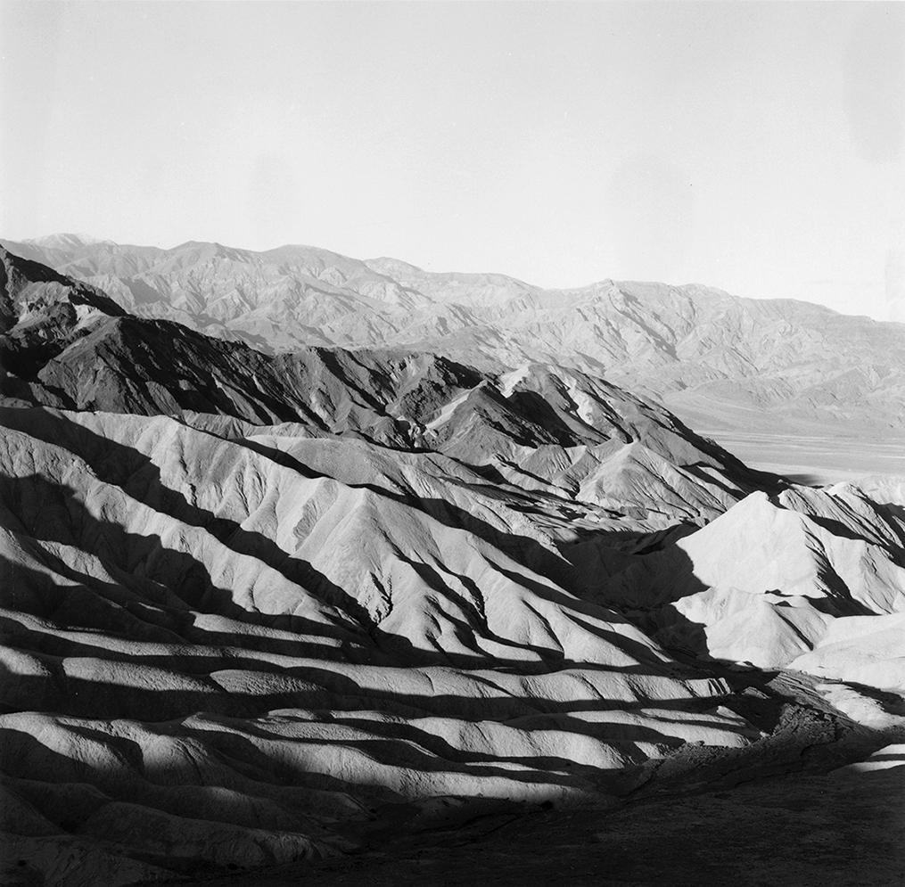 Furrows in the Death Valley landscape travel away from the viewer toward distant mountains (right half of diptych)