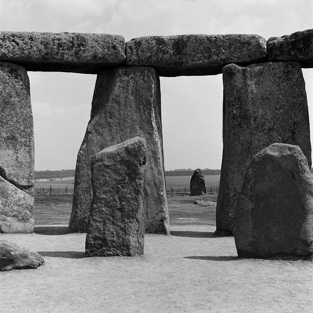 Within the circle at Stonehenge, inner vertical bluestones are dwarfed by the surrounding ring of sarsen standing stones (13 feet high by 7 feet wide), crowned by horizontal lintel stones.