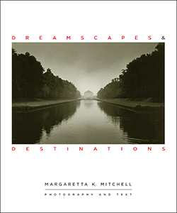 On the Dreamscapes book cover, a distant palace appears at the far end of a wide canal surrounded by sky above and forest left and right, plus their symmetrical reflection in the foreground.